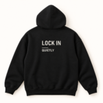 Back of black hoodie with LOCK IN, a thin divider, and QUIETLY printed in off-white